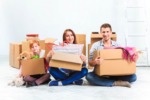 Team using safe lifting techniques during a house move