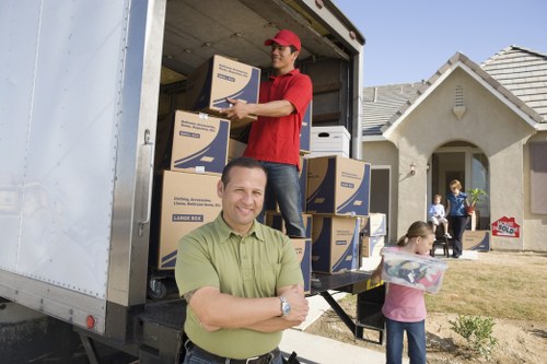 Professional movers carrying boxes during a Catford relocation