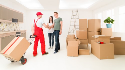 A moving team organizing fragile household items during packing in Catford